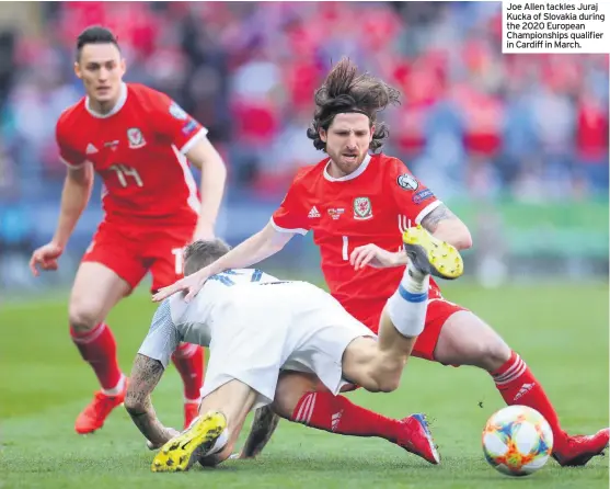  ??  ?? Joe Allen tackles Juraj Kucka of Slovakia during the 2020 European Championsh­ips qualifier in Cardiff in March.