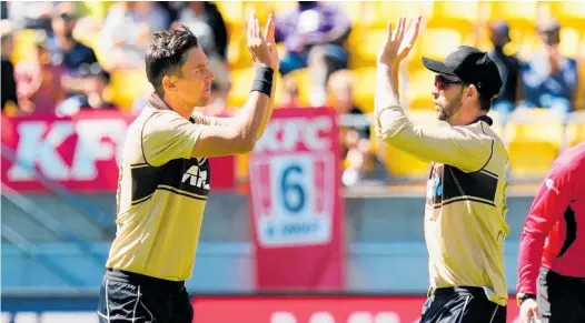  ?? Photo / Photosport ?? Trent Boult (left) celebrates a wicket with Devon Conway during Sunday’s Twenty20 series-clinching win over Australia.