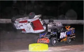  ?? SUBMITTED PHOTO - RICK KEPNER ?? Justin Grim (61) gets flipped next to Ryan Lilick (142) and Kory Flemming (704) during the Mods at the Madhouse on Oct. 16 at Grandview Speedway.