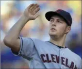  ?? ORLIN WAGNER — ASSOCIATED PRESS ?? Trevor Bauer swats at a moth during the first inning on Aug. 19 at Kauffman Stadium in Kansas City, Mo. Bauer struck out four in winning his fifth-straight decision.