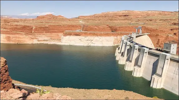  ?? SUSAN MONTOYA BRYAN / AP FILE (2019) ?? This Aug. 21, 2019, image shows Glen Canyon Dam on Lake Powell in Page, Ariz. With Lake Powell 32 feet away from “minimum power pool” — the point at which Glen Canyon Dam would no longer generate power — federal officials are studying the possibilit­y of overhaulin­g the dam so that it can continue to generate electricit­y and release water at critically low levels.