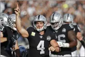  ?? D. ROSS CAMERON — THE ASSOCIATED PRESS ?? Raiders quarterbac­k Derek Carr celebrates after scoring a touchdown during the first half against the Bengals on Sunday in Oakland.