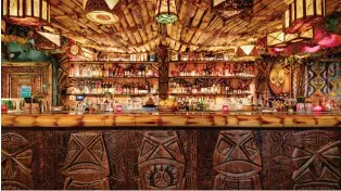  ??  ?? False Idol tiki bar serves up Akala the Fierce, a vast moat of booze that lives up to its name. ZACK BENSON
