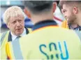  ?? REUTERS ?? Boris Johnson speaks with airport workers in Southampto­n.