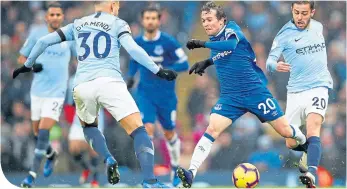  ??  ?? Everton’s Bernard is challenged by Nicolas Otamendi and Bernardo Silv