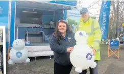  ?? ?? Canal & River Trust events co-ordinator Sarah Potts with volunteer Paul Fallows at the welcome trailer, complete with Sarah’s own balloon version of the Well-B mascot.