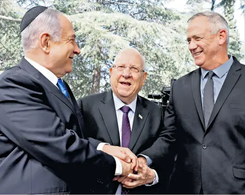  ??  ?? Benjamin Netanyahu, Reuven Rivlin and Benny Gantz were all smiles and handshakes for the cameras at a memorial event for Shimon Peres, the late Israeli president, yesterday