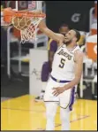  ?? Associated Press ?? IN THERE — Lakers guard Talen Horton-Tucker, left, dunks against the Clippers in Los Angeles on Dec. 13. The Lakers open the regular season against the Clippers today.