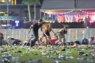  ?? AFP ?? People scramble for cover after hearing gunshots at the Route 91 Harvest country music festival in Las Vegas, Nevada, on Sunday.