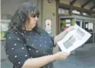  ?? Eric Risberg, The Associated Press ?? Jessica Tunis on Wednesday shows a flyer about her missing mother outside a Red Cross evacuation center in Santa Rosa, Calif.
