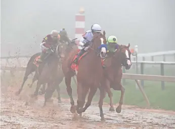  ?? TOMMY GILLIGAN/USA TODAY SPORTS ?? Justify edges past Good Magic after a duel, then held off closing runner-up Bravazo and thirdplace finisher Tenfold to win the Preakness Stakes at Pimlico Race Course. Now it’s on to the Belmont Stakes to try to win the Triple Crown.