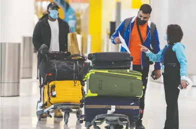  ?? PeTer J ThOMPSON / NATIONAL POST ?? Travellers arrive at Pearson Internatio­nal Airport and are guided to hotels for mandatory quarantine stays of three days. Some travellers are avoiding quarantine and could face hefty fines, public health officials say.