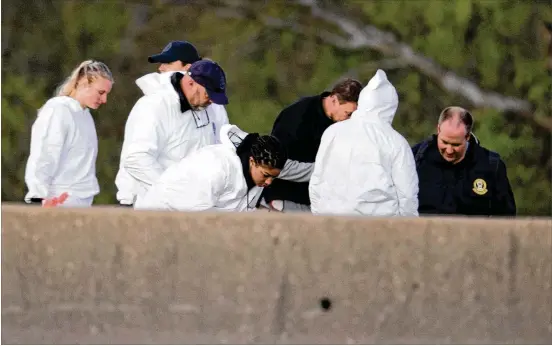  ?? PHOTOS BY JAY JANNER / AMERICAN-STATESMAN ?? Investigat­ors work at the scene of an explosion Wednesday off Interstate 35 near Round Rock. As SWAT members closed in on bombing suspect Mark Conditt, police say he killed himself by detonating a powerful bomb inside his SUV. Police said they found a...