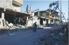  ?? (Ahmed Jadallah/Reuters) ?? A MAN WALKS past the ruins of homes in Sirte, Libya, on November 1. The devastatio­n was caused by combat between Libyan forces and ISIS gunmen.