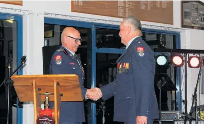  ?? Photo / Supplied ?? Te Puke Volunteer Fire Brigade chief fire officer Glenn Williams, left. presents station officer Ivon Pilcher with his Gold Star for 25 years’ service — all with the Te Puke brigade.