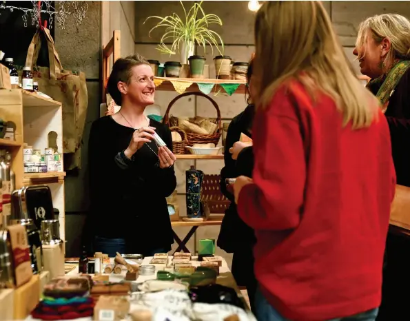  ??  ?? ABOVE Kim Lawlor, founder of Earthlove, in her element at the Christchur­ch Art Gallery market. Kim operates her permanent stall from 105 New Brighton Mall, at the Arts Centre Mākete on Sundays and online at earthlove.co.nz
OPPOSITE Kim and her husband, Eoin, at their second Christchur­ch Go Green Expo. Kim launched Earthlove at the 2018 Expo and has since participat­ed in markets and events all across New Zealand, with Eoin supporting her business and mission. Photo supplied.