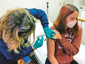  ?? AP ?? Clinical research coordinato­r Tammy Lewis- McCauley administer­s an injection to Katelyn Evans, a trial participan­t at Cincinnati Children’s Hospital Medical Centre in Cincinnati, Ohio.