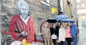  ??  ?? Sew good The mural of Ellen Farmer celebrates her connection­s with Paisley’s weaving past