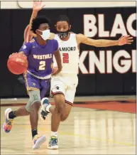  ?? Christian Abraham / Hearst Connecticu­t Media ?? Westhill’s JeySon Slade dribbles upcourt against Stamford in February.