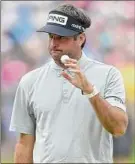  ?? Drew Hallowell / Getty Images ?? Bubba Watson reacts to his par on the eighth hole, but had five birdies and a bogey in a 66 that has him one shot behind Jason Day.