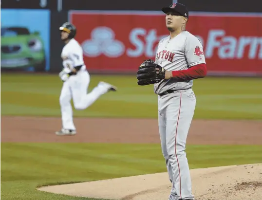  ?? AP PHOTO ?? ROUGH NIGHT: Sox starter Hector Velazquez looks away as Oakland’s Jed Lowrie rounds the bases after hitting first-inning homer.