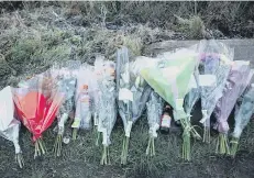  ??  ?? Floral tributes left at the scene for the two men