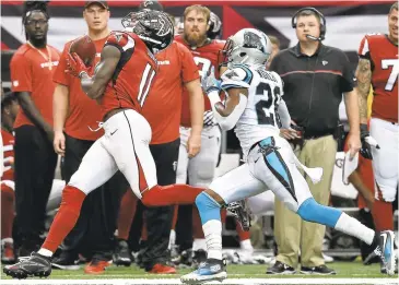  ?? RAINIER EHRHARDT/ ASSOCIATED PRESS ?? Atlanta Falcons wide receiver Julio Jones makes a catch against Carolina Panthers cornerback Daryl Worley on Sunday. Jones burned almost every defensive back the Panthers used against him — especially rookie James Braderry — in making 12 catches for...