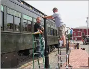  ??  ?? Volunteers install streetligh­ts at the Colebrookd­ale Railroad station at 64S. Washington St., Boyertown.