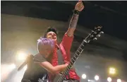  ?? JANE TYSKA/STAFF ?? A fan hugs Green Day’s Billie Joe Armstrong on Thursday. .