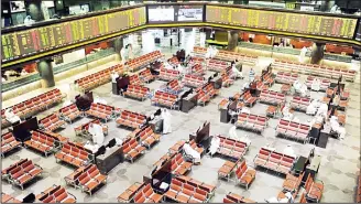  ??  ?? Traders watch share movements as Boursa Kuwait ended trading Tuesday on the green zone as the premier
market index went up 57.09 points to reach 5,302.31 points. (KUNA)