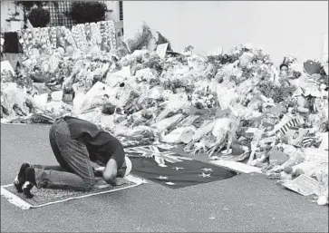  ?? Mick Tsikas EPA/Shuttersto­ck ?? CRISIS TEAMS at YouTube took unpreceden­ted steps to speed the removal of videos of the mosque massacre in New Zealand. Above, a worshiper prays at a memorial on Tuesday at the Al Noor Mosque in Christchur­ch.