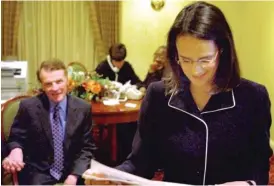  ?? AP FILES ?? ABOVE: Lisa Madigan reads an article about herself as her father, Illinois House Speaker Michael Madigan, watches her as they await election results on the night of the 2002 Democratic primary.