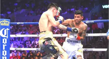  ??  ?? Leo Santa Cruz (left) battles to defeat Abner Mares in their WBA Featherwei­ght Title &amp; WBC Diamond Title fight at Staples Centre in Los Angeles, California.