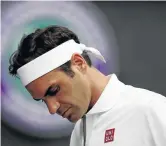  ?? /MATTHIAS HANGST/GETTY IMAGES ?? Roger Federer of Switzerlan­d reacts following defeat.