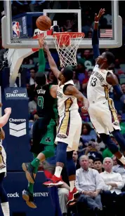  ?? AP ?? Boston Celtics’ Jayson Tatum ( left) goes for a basket against Darius Miller and forward Cheick Diallo ( right) of New Orleans Pelicans in their NBA game in New Orleans on Sunday. The Pelicans won 108- 89. —