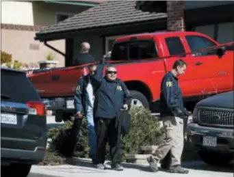  ?? JAE C. HONG — THE ASSOCIATED PRESS ?? FBI agents leave the house of shooting suspect David Ian Long in Newbury Park on Thursday. Authoritie­s said the former Marine opened fire at a country music bar in Southern California on Wednesday evening.