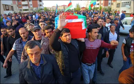  ??  ?? أذربيجانيو­ن يحملون نعش أحد أفراد القوات المسلحة الذي قتل خلال المعارك الدائرة على الحدود مع أرمينيا