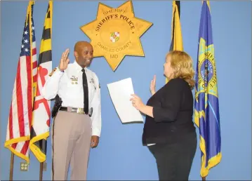  ?? STAFF PHOTO BY ANDREW RICHARDSON ?? Charles County Sheriff Troy Berry is sworn in by Clerk of Circuit Court Sharon Hancock as the Southern Maryland representa­tive of the Maryland Police Training and Standards Commission.