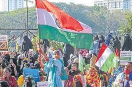  ?? PTI ?? A girl waves the Tricolor during a protest in Mumbai on Saturday to support the farmers’ ongoing agitation against the new farm laws in Delhi.