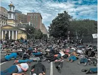  ?? DANIEL SLIM/GETTY-AFP ?? Protesters lie Tuesday in front of Lafayette Square, where many were tear gassed the evening before, in Washington.