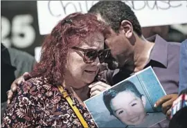  ?? Liz Moughon Los Angeles Times ?? EVA HERNANDEZ, great-grandmothe­r of Noah Cuatro, a 4-year-old boy who died on July 6, is comforted by activist Najee Ali at a news conference Tuesday.