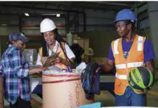  ?? ?? A Customs Officer (centre) processes a barrel shipment for a customer at a warehouse in Kingston, meanwhile the warehouse handler looks on. The new Time Release Study (TSR) is expected to improve the actual time taken to conduct transhipme­nt activities such as the clearing of barrels/goods in Jamaica.