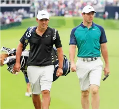  ??  ?? Rory McIlroy of Northern Ireland walks with caddie Harry Diamond on the first hole during a practice round at Bellerive Country Club in St Louis, Missouri. — AFP photo