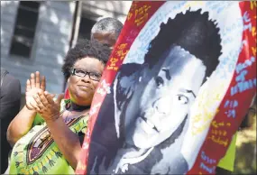  ?? Arnold Gold / Hearst Connecticu­t Media ?? Demethra Telford takes part in the march in the Newhallvil­le section of New Haven on Sunday and talks about her son, Tyriek Keyes, shown in poster, who was shot to death two months ago.