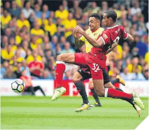  ??  ?? New Watford striker Andre Gray is tackled by Joel Matip.