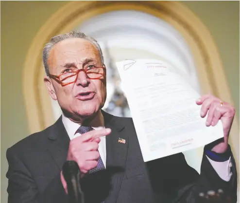  ?? MANDEL NGAN / AFP / GETTY IMAGES ?? Senate Minority Leader Chuck Schumer speaks to reporters Wednesday in Washington, D.C., as he holds a transcript
of the phone call between U. S. President Donald Trump and Ukrainian President Volodymyr Zelensky.