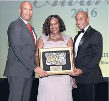  ??  ?? Caribbean Producers Jamaica’s Dr David Lowe (left) presents the Best Boutique/Small Hotel Award to Round Hill’s Hillary Stewart and Omar Robinson.