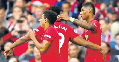  ?? AP ?? Manchester United’s Marcus Rashford (right) celebrates with teammates after scoring his side’s first goal during the English Premier League match against Chelsea at Old Trafford in Manchester, England, on Sunday. Manchester United won 4-0.