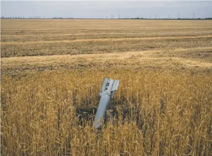 ?? WOJCIECH Grzedzinsk­i FOR The WASHINGTON POST ?? An unexploded rocket in a farm field in Ukraine, which along with Russia was among the world’s top producers of grain before the war. Since the invasion, over 20 million tons of grain have been stuck in Ukraine’s Black Sea ports, causing worldwide shortages.