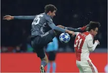  ?? PETER DEJONG THE ASSOCIATED PRESS ?? Ajax’s Nicolas Tagliafico, right, is fouled by Bayern’s Thomas Mueller during the match between Ajax and Bayern Munich on Dec. 12.